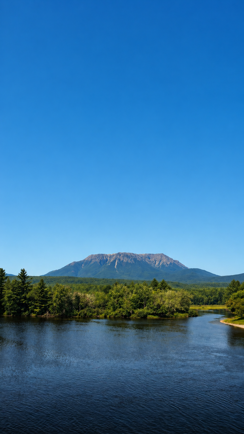 Mountain landscape with river beneath a clear sky